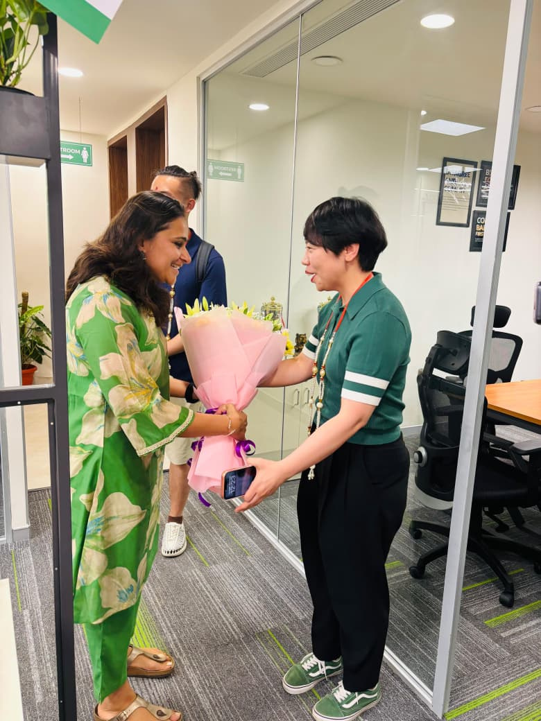 Valuecart team welcoming a partner with flowers